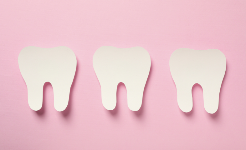 Three paper cut outs of healthy teeth against a bright pink background.