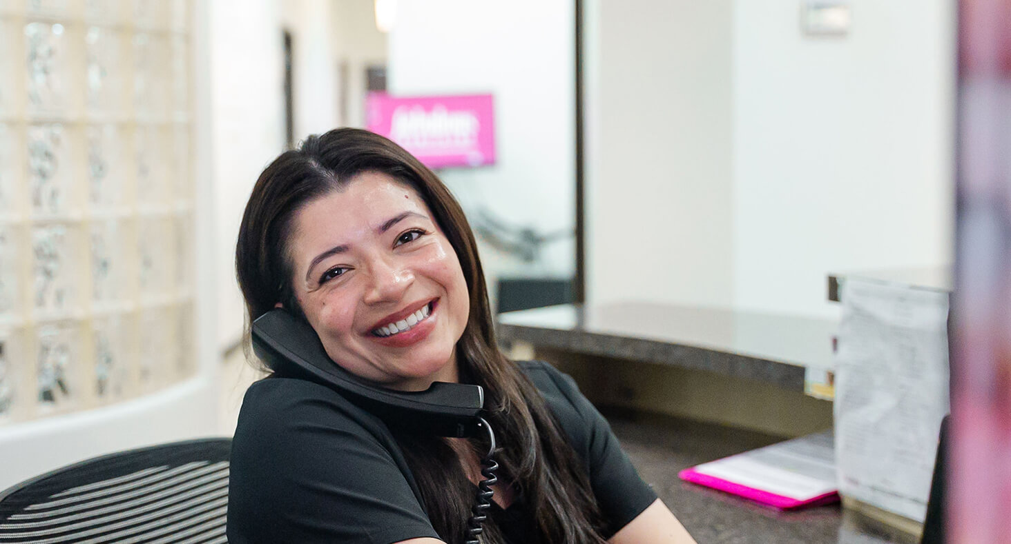 Dental receptionist smiling