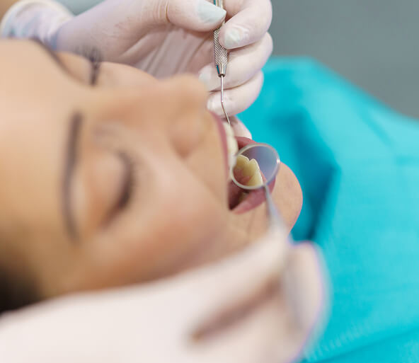 dentist checking a patient's mouth